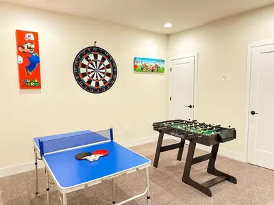 a room with a table and a dart board at TR1386PNW - 9 guests - pool home close to Disney in Clermont