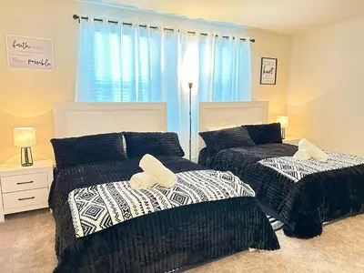 a bedroom with two beds and a window at TR1386PNW - 9 guests - pool home close to Disney in Clermont