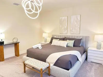 a bedroom with a large bed and a couch at TR1388PNW - Modern New Home 4 Bed in Clermont