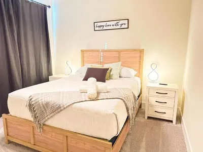 a bedroom with a large bed and a night stand at TR1388PNW - Modern New Home 4 Bed in Clermont