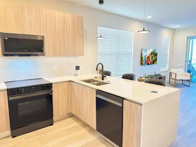 a kitchen with a sink and a stove top oven at TR1388PNW - Modern New Home 4 Bed in Clermont