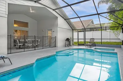 a swimming pool in the middle of a house at Spacious Disney Retreat with pool & parking in Kissimmee