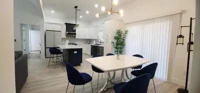 a kitchen and dining room with a table and chairs at Orlando Home Vacation near Universal Studios - 3 BR in Orlando