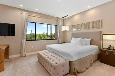 a bedroom with a large bed and a large window at Casa 3 Suítes c/ Jacuzzi e Churrasq. — Disney 6min in Orlando
