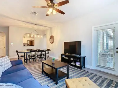 a living room with a blue couch and a table at Windsor Hills Lovely 3BR Condo Slides Pool Disney in Orlando