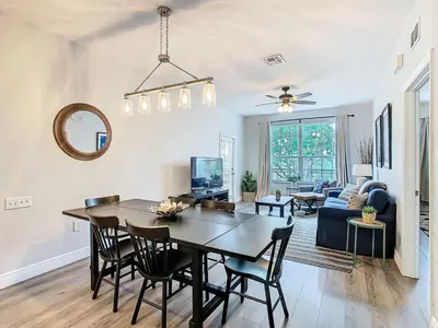 a dining room and living room with a table and chairs at Windsor Hills Lovely 3BR Condo Slides Pool Disney in Orlando