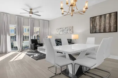 a dining room with a white table and chairs at 3 Bedroom Spacious Condo at WorldQuest near Disney- 22749 in Orlando