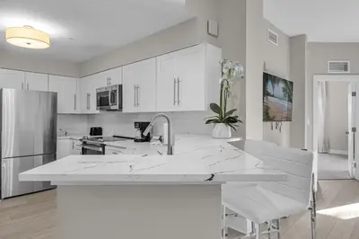 a white kitchen with a sink and a refrigerator at 3 Bedroom Spacious Condo at WorldQuest near Disney- 22749 in Orlando