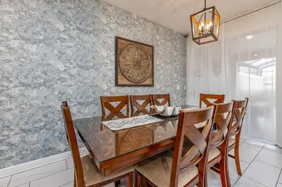 a dining room with a table and chairs at Amazing Townhouse TVPM in Kissimmee