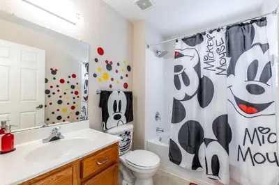 a bathroom with a toilet and a shower curtain at Spectacular townhouse with themed room in Kissimmee