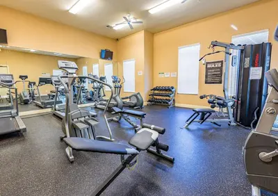 a gym with several treadmills and exercise bikes at Spectacular townhouse with themed room in Kissimmee
