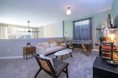a living room with a couch and a table at Ravello Villa Storey Lake in Kissimmee