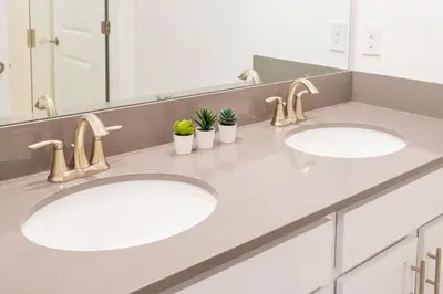 two sinks in a bathroom with two mirrors at La Vita E Bella 4 Bedroom Storey Lake Condo in Kissimmee