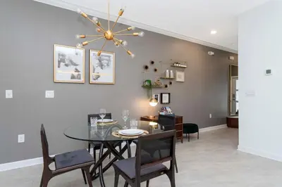 a dining room with a table and chairs at La Vita E Bella 4 Bedroom Storey Lake Condo in Kissimmee
