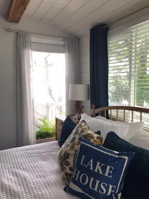 a bedroom with a bed with a large window at Lakefront with Dock on Private Lake Florence near Montverde Academy in Montverde