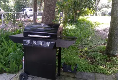a bbq grill with a pot on top of it at Lakefront with Dock on Private Lake Florence near Montverde Academy in Montverde