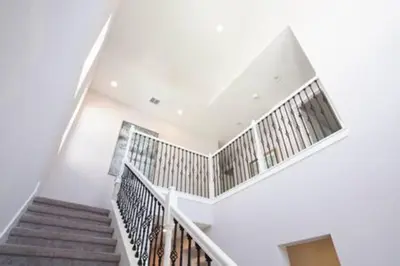 a staircase in a house with white walls at Exclusive Orlando Getaway close to Disney in Kissimmee