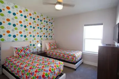 a bedroom with a bed and a couch and a window at Exclusive Orlando Getaway close to Disney in Kissimmee