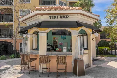 a tiny bar with stools in front of a building at 2 Bedroom Condo 6403 in Orlando