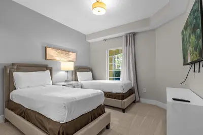 a bedroom with two beds and a window at WorldQuest Resort in Orlando
