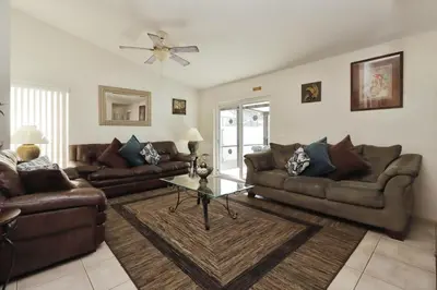 a living room with two couches and a table at Ideal for Couples or Families looking for a Vacation Home with Private Pool and Yard in Kissimmee