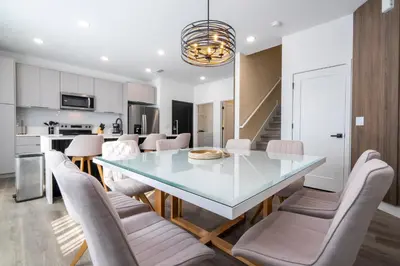 a kitchen and dining room with a glass table and chairs at Doppio Westside in Orlando