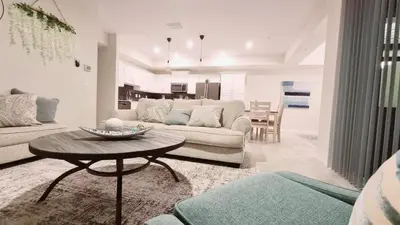 a living room with a couch and a table at Stunning Storey Lake Resort and Game room in Kissimmee