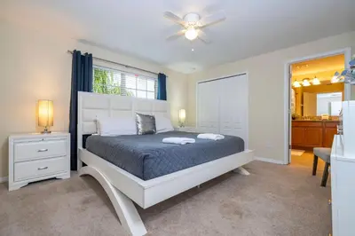 a bedroom with a bed and a ceiling fan at Nice Vacation Townhouse w Pool SL4893 in Kissimmee