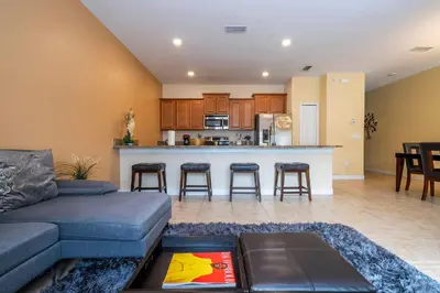 a living room with a couch and a kitchen at Nice Vacation Townhouse w Pool SL4893 in Kissimmee