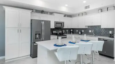 a white kitchen with white cabinets and white appliances at PXC3151-102 in Kissimmee