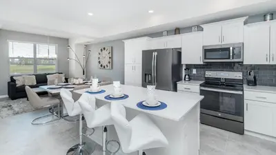 a kitchen with a table and chairs in a room at PXC3151-102 in Kissimmee