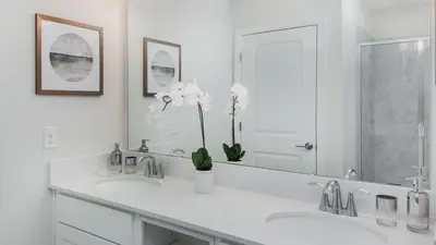 a white bathroom with two sinks and a mirror at PXC3151-102 in Kissimmee