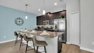 a kitchen with a large island with bar stools at GAS3070 in Kissimmee