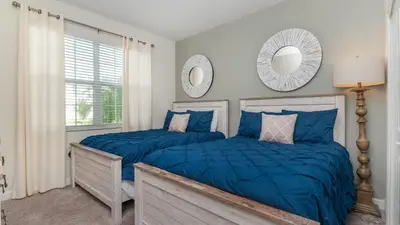 two beds in a bedroom with blue comforter at KCC 4797 in Kissimmee