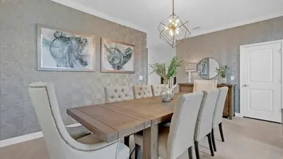 a dining room with a wooden table and chairs at PLW4277 in Kissimmee