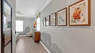 a hallway with paintings on the wall in a house at PLW4277 in Kissimmee