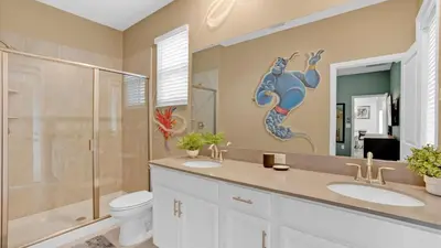 a bathroom with two sinks and a toilet and a shower at PLW4277 in Kissimmee