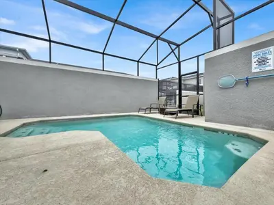 an indoor swimming pool with a glass ceiling at QTS4361 in Kissimmee