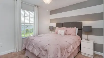 a bedroom with a large bed and a window at KCC4741 in Kissimmee