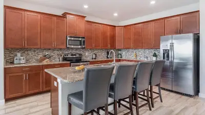a kitchen with wooden cabinets and stainless steel refrigerator at KCC4741 in Kissimmee