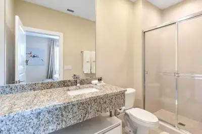 a bathroom with a sink and a toilet and a shower at Magical & Spacious Home Minutes from Disney Parks in Orlando