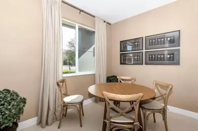 a dining room with a table and chairs and a window at Magical & Spacious Home Minutes from Disney Parks in Orlando