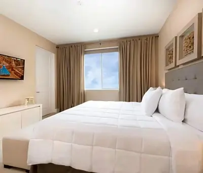 a bedroom with a large white bed with a window at Magical & Spacious Home Minutes from Disney Parks in Orlando