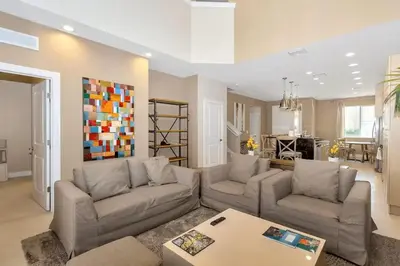 a living room with two couches and a table at Magical & Spacious Home Minutes from Disney Parks in Orlando