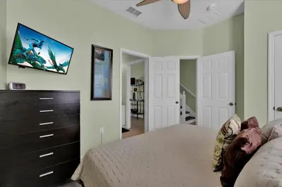 a bedroom with a bed and a tv on the wall at Windsor Hills 3 Bedroom Private Pool Townhome 0858 in Orlando