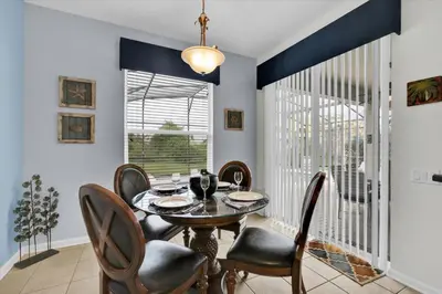 a dining room with a table and chairs at Windsor Hills Resort 5 Bedroom Updated Pool Home 0853 in Orlando