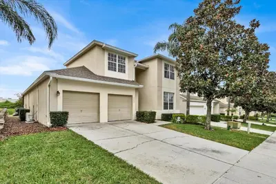 a house with a tree and a driveway at Windsor Hills Resort 5 Bedroom Updated Pool Home 0853 in Orlando