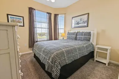 a bedroom with a bed and a window at Windsor Hills Resort 3 Bedroom 4th Floor Condo with Resort Access 0946 in Orlando