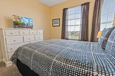 a bedroom with a bed and a dresser and a window at Windsor Hills Resort 3 Bedroom 4th Floor Condo with Resort Access 0946 in Orlando