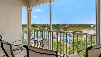 a balcony with chairs and a view of a pool at Windsor Hills Resort 3 Bedroom 4th Floor Condo with Resort Access 0946 in Orlando